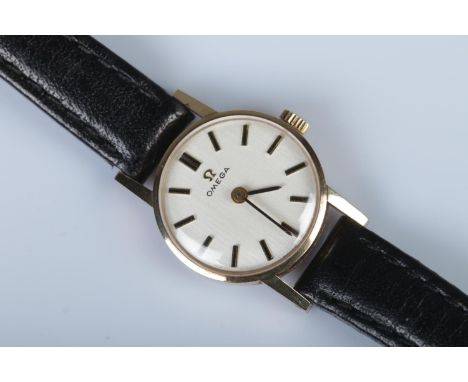 A ladies 9ct gold Omega manual watch with baton markers to the dial and black leather strap.  Appears to be running.