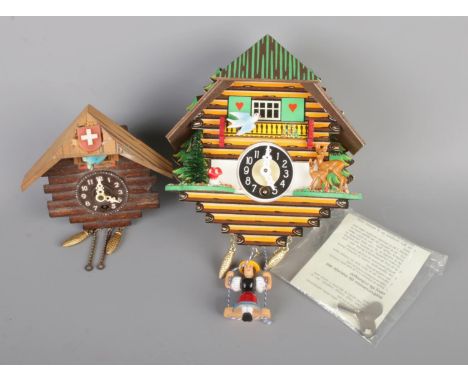 Two decorative cuckoo clocks, both come with keys and one boxed with manual. Height 11cm and 15cm.