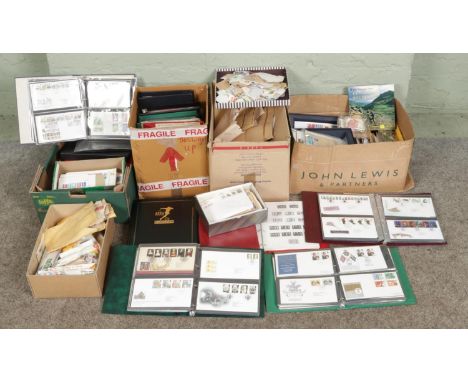 Four boxes containing large collection of UK and world stamped envelopes, loose stamps and assorted first day cover albums, i