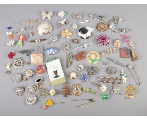 A large collection of costume jewellery brooches, tie slides and scarf rings to include Stratton, floral, ceramic, poppy and 