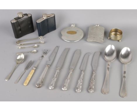 A collection of vintage silver-plated flatware and spirit flasks.