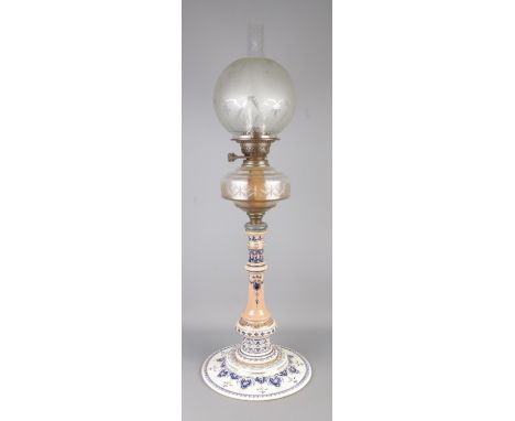A Victorian blue and white ceramic oil lamp featuring cut glass reservoir and frosted shade, stamped British Made to double b
