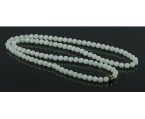 A vintage Buddhist prayer meditation mala, featuring 108 of 8mm cream jade beads with silver guru bead, strung without clasps