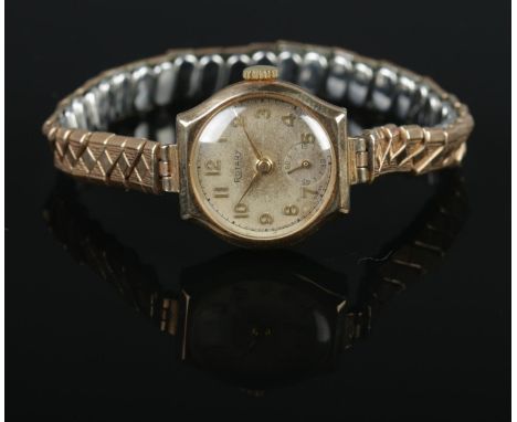 A 9ct Gold cased ladies Rotary manual wind wristwatch, on expanding Excalibur strap. The silvered dial featuring Arabic Numer