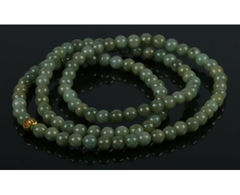 A vintage Buddhist prayer meditation mala, featuring 108 of 8mm dark jade beads with gold guru bead, strung without clasps. B