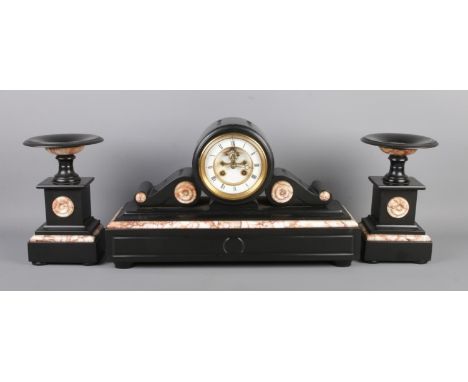 An antique slate and marble 8 Day mantel clock garniture, pair with two matching tazza-style stands. Clock with visible escap