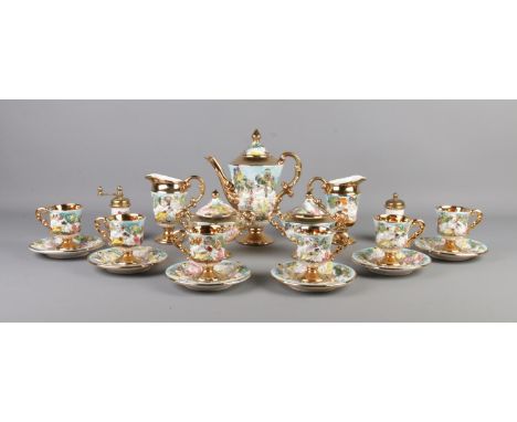 A Capodimonte style tea service featuring gilt edging and decorated with cherubs. Comprising of cups, saucers, teapot, milk j