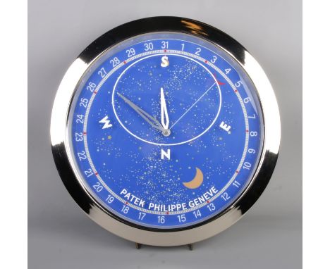 A Patek Philippe watch style wall clock, featuring a silver bezel and blue celestial dial.  Quartz movement, working, diamete