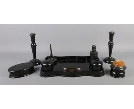 An ebony dressing table set, containing candlesticks, trinket box, pin cushion and ring holder etc.  Repair to the base of th