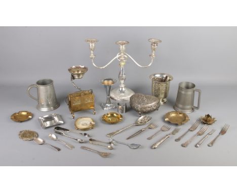 A box of assorted metalwares, to include three branch candelabra, tankard, ashtray, silver handled flatware and heart-shaped 