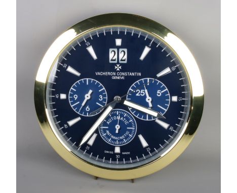 A Vacheron Constantin "Overseas" watch style wall clock, gold surround with blue dial.  Quartz movement, working, diameter 40