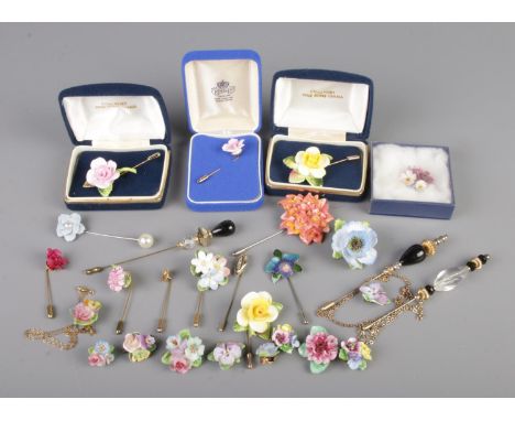 A small tray of stick pins and brooches predominantly floral examples.