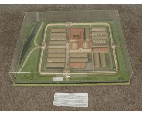 A cased diorama model depicting a Roman auxiliary fort complete with buildings and surrounding landscape. Model originally pa
