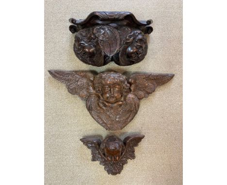 one in oak the other limewood, together with another 17th century style carved oak bracket on double putti support, the large