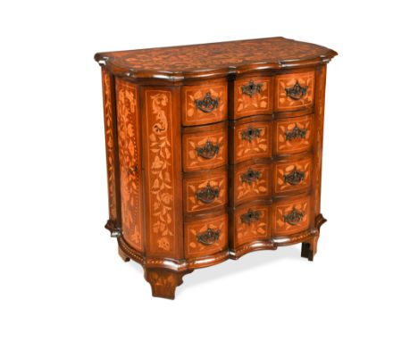 the shaped top with central urn motif within flowers, birds and butterflies, over four long drawers with flanking side cupboa