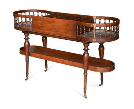 the bowed ends with turned galleries flanking cutlery dividers to centre raised on ring turned tapering legs with shelf below