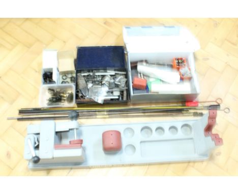 A large quantity of gun parts, tools and accessories including a Tipton rifle vise, cleaning rods, sight mounts, etc