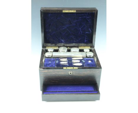 A 19th Century coromandel dressing table box, having a fitted interior with four silver topped bottles, and a lift out tray, 