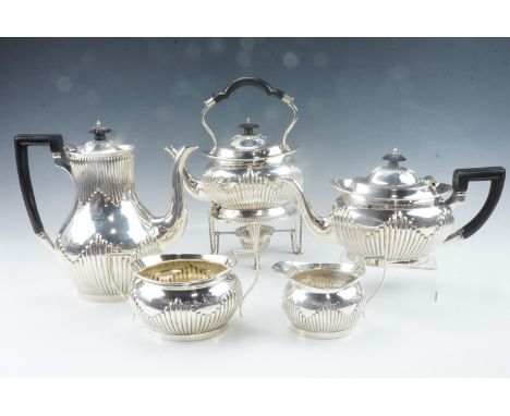 A late Victorian Mappin and Webb five piece silver tea service including a spirit kettle, of Georgian design having part reed