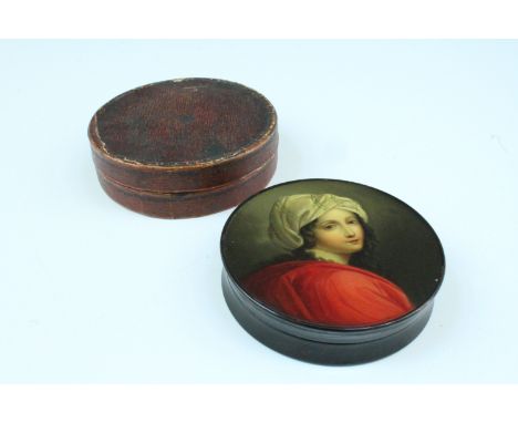 A mid 19th Century circular papier mache table snuff box, bearing a polychrome image of Beatrice Cenci, in its original leath