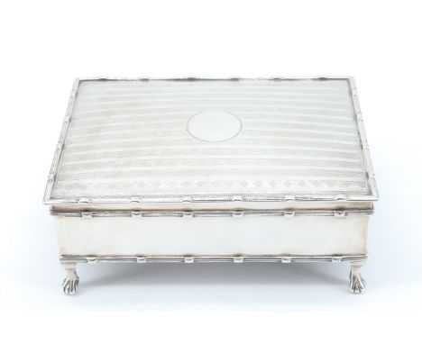 An Edwardian silver table box, its subtly domed hinged lid decorated with banded engine turning centred by a vacant circular 