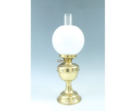 A brass oil lamp having a milk glass globe / shade, 52 cm to top of funnel 