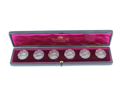 A cased set of six Belle Epoque white metal buttons, bearing a depiction of a young maiden with Convolvulus, on a petal influ
