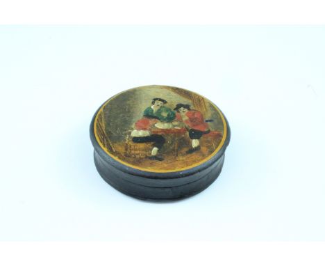 A 19th Century circular lacquered snuff box, having a hand coloured printed scene of gamblers, 2 x 6.5 cm diameter