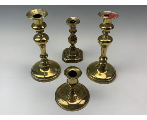 A pair of Victorian brass inverted baluster candlesticks, together with a Georgian brass candlestick and one other stick