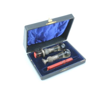 An Edwardian cased silver and faceted smoky quartz desk seal set, comprising a wax holder and a seal, each formed as a thistl