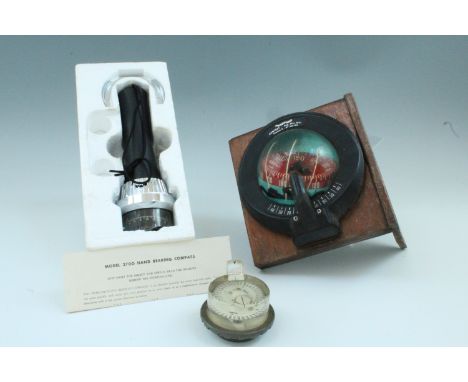 Sestrel and Plastimo marine compasses together with a Yokahama Compass Manufacturing Co hand bearing compass