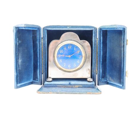 A George V silver boudoir clock, of Art Deco influenced shouldered "cloud" form, standing on bun feet, the key-wound 8-day mo