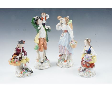 A pair of Sitzendorf Rococo influenced early 20th Century porcelain figurines, comprising husband and wife with children on t