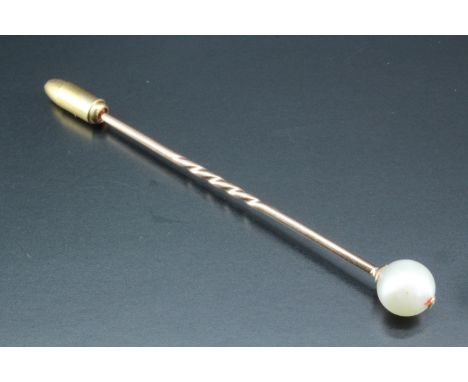 A late 19th / early 20th Century yellow metal stick pin having a pearl terminal, latter 7 mm, 1.3 g