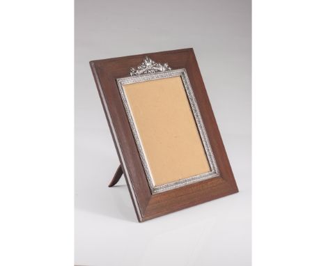 A FABERGE photo frameRectangular mahogany frameApplied silver 917/000 (88 zolotniks) elementsEngraved decoration with torches