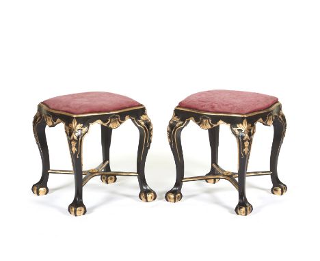 A pair of João V style stoolsCarved, gilt and painted walnut of shells and foliage motifsX shaped stretchersClaw and ball fee