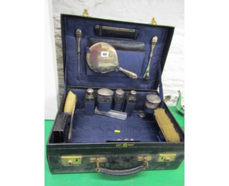 TRAVELLING SET, leather travel case, the partially fitted interior includes 6 silver topped jars, silver backed mirror and br