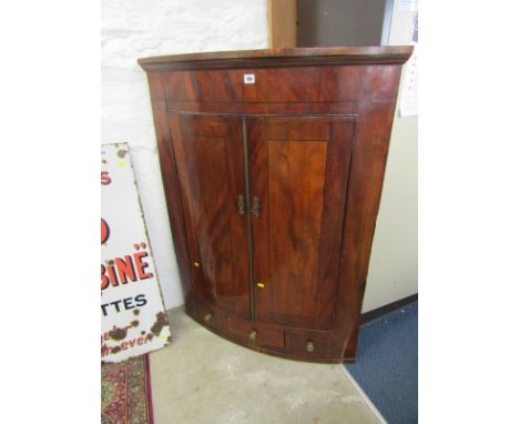 LATE GEORGIAN HANGING CORNER CUPBOARD, inlaid mahogany twin door bow front corner cupboard with single drawer base with match