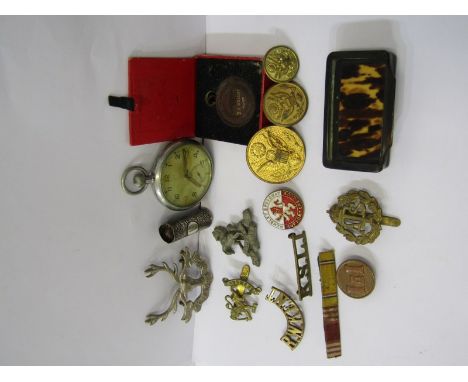 MILITARY, a plated pocket watch with military marks to rear, collection of assorted cap badges, ebony snuff box etc. 