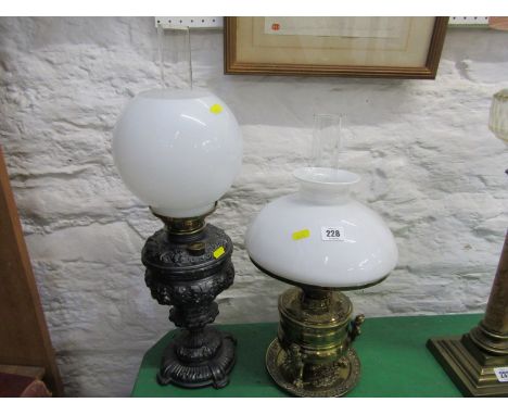 OIL LAMPS, Edwardian ornate brass base oil  lamp supported by 3 caryatid with milk glass shade; together with 1 ornate metal 