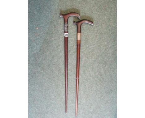 ANTIQUE WALKING STICKS, Chinese silver mounted, together with similar one with plated mount, both with flexible shafts 