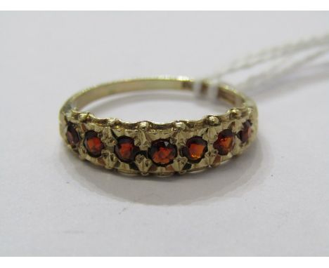 9ct YELLOW GOLD 7 STONE GARNET SET ETERNITY STYLE RING, size Q/R 