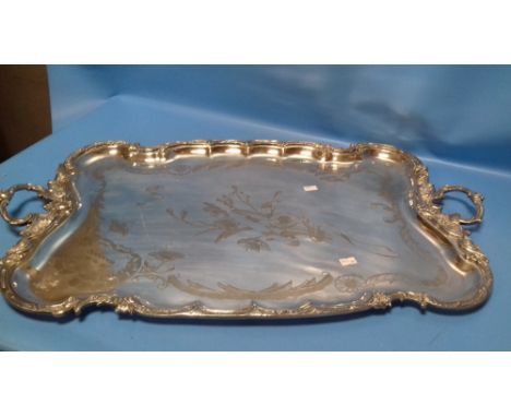 A LARGE SILVER PLATED ART NOUVEAU TWIN HANDLED TRAY