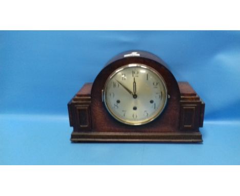 AN OAK MANTEL CLOCK