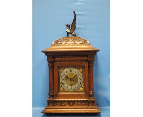 AN OAK CASED MANTEL CLOCK