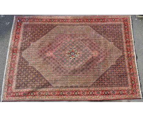 A vintage 20th century circa 1970s Persian Islamic Senneh carpet floor rug. Having hexagonal form central medallion encapsula