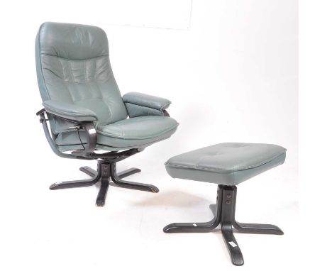 A vintage 20th century Ekornes Stressless manner swivel armchair. The armchair upholstered in dark green leather, raised on a