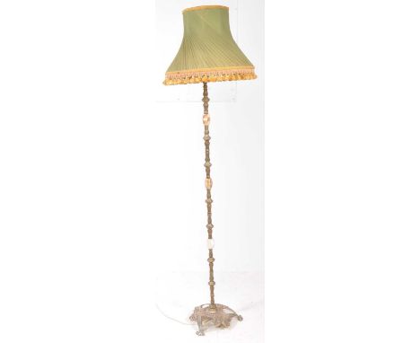 A vintage mid century onyx floor standing standard lamp. Having a green twist lamp shade with tassled fringe. Brass and onyx 