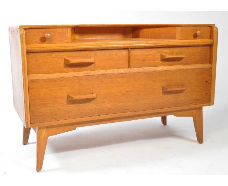 E. Gomme- G Plan - Brandon Range - A retro vintage 20th Century light oak dressing table chest. The top with recessed drop ce