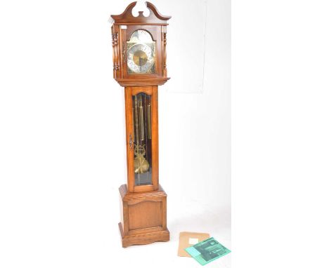 Emporer Clock Co. A Longcase clock with moonphase action having brass dial and set within mahogany hood and trunk. Brass weig